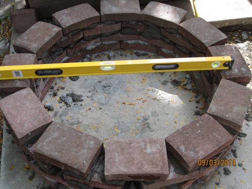Here I'm up to 4 courses of bricks for the ring, and trying to keep everything level