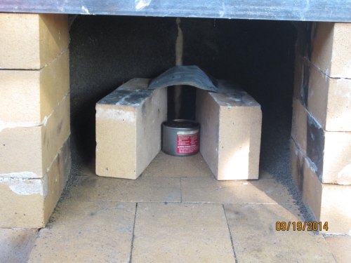 I am impatient, so I start scraping sand out of the dome after only 2 days.  My plan is to speed the drying by using some Sterno inside the dome while leaving some of the sand for support.  It seemed to work.  The dome did not collapse and after 3 cans of Sterno I got most of the sand out. 