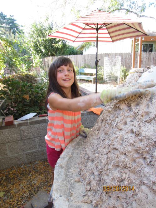 Chloe putting the finishing touches on the first insulation layer.  Notice the divots in the insulation.  This is so that the next layer will bond to it. 