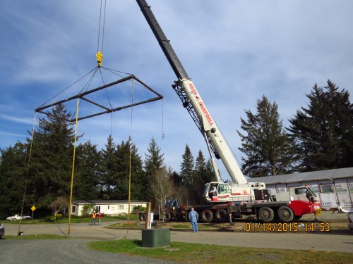 This crane is waiting to off load the last piece of the medical office.