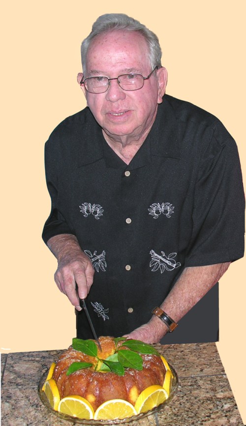 Chuck Barrett is pictured here with his signature orange cake.  Made from scratch, his secret ingredient is Triple sec.  Whenever he is invited to a gathering, he brings his cake and garners rave  reviews.  The ladies in the group are are always impressed with his baking skills. 