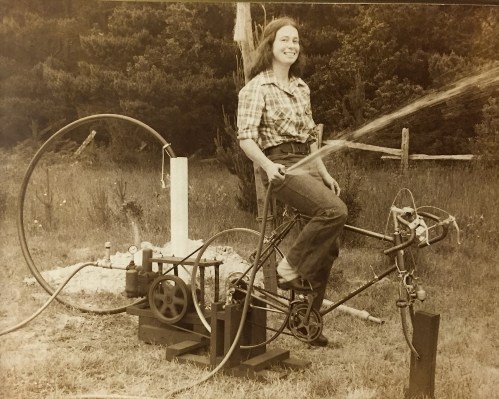 This was probably about 40 years ago, my sweetheart is showing how my bicycle can pump water.  We had bought an old (very old) Fairbanks-Morse water pump and I think we were testing it out.